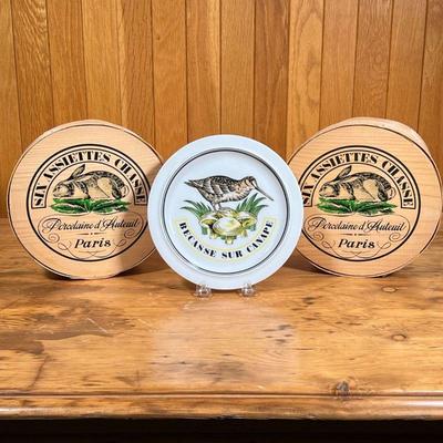 (12pc) PORCELAINE D'AUTEUIL PLATES  |
Two boxes of 7.75-inch "Assiettes Chasse" - h. 3.25 x dia. 8 in. (each box)