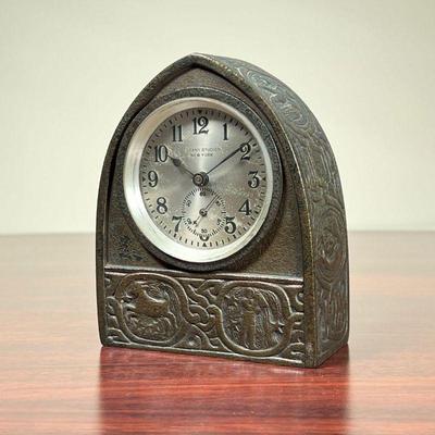TIFFANY ZODIAC CLOCK  |  
Tiffany Studios New York desk clock with an arched bronze case, having zodiac designs replete with matching key...