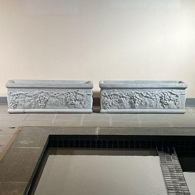 (2pc) PAIR CONCRETE PLANTERS  |
Two large concrete planters with ornate designs - l. 39.5 x w. 13.5 x h. 13.5 in.