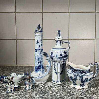 (6pc) DELFT & OTHER PORCELAIN  |
Including two Delft figural pitchers with a blue underglaze decoration and both signed on the...