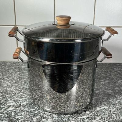 STAINLESS STEEL STEAMING POT  |
Stainless steel with wood handles, no apparent markings, a 7.25  inch tall pot with a 10.75  inch...