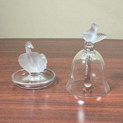 (2pc) LALIQUE FROSTED GLASS  |  
Including a ring dish with central frosted glass swans and a crystal glass bell with a frosted bird...