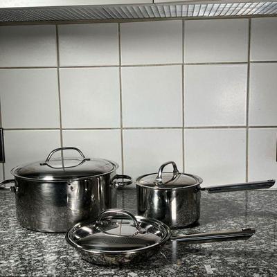 (3pc) CUISINART COOKWARE  |
Stainless steel, including an 8.25 inch Cuisinart frying pan and lid (lid not perfectly fitting), an unmarked...