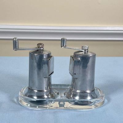 PERFEX SALT & PEPPER MILLS  |
French stainless steel salt and pepper mills on a conforming acrylic stand (l. 6.25 in.) - h. 4.25 in.