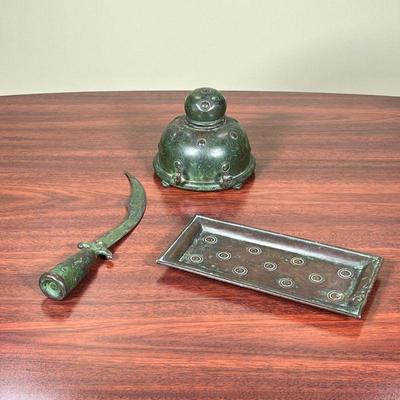 (3pc) APOLLO STUDIOS DESK ARTICLES  |  
Including a patinated copper inkwell, a letter opener, and a small tray, stamped on the bottom,...