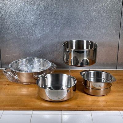 (4pc) CUISINART STEAMER INSERTS  |
Stainless steel steaming pot inserts, one brand new in plastic wrap, all marked on the bottom - dia....