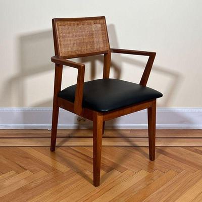 MID-CENTURY ARMCHAIR  |  
Mid century modern wood arm chair with a black leather cushion seat (removable) and a caned back - l. 20 x w....