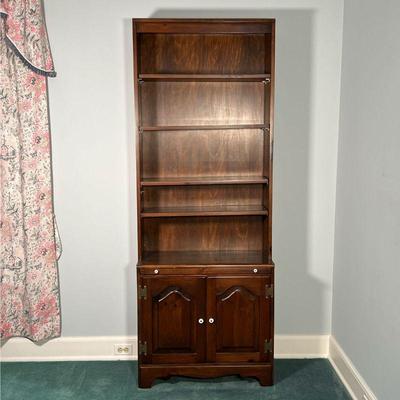 WOODEN BOOKCASE  |
Dark wood bookcase with four adjustable shelves over a pull out writing surface over double cabinet doors, having...