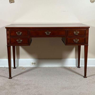 BAKER WRITING DESK  |
With two banks of two small drawers centering same middle drawer, with blind fretwork decoration, and a nicely...