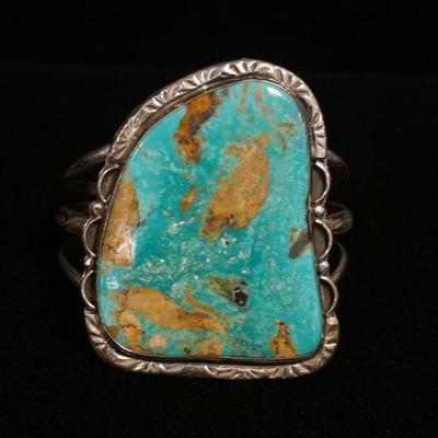 1253	STERLING SILVER CUFF BRACELET W/LARGE TURQUOISE MEASURING 2 1/2 IN X 33/4 IN, SMALL CRACK IN THE TURQUOISE, 2.263 OZT INCLUDING STONE
