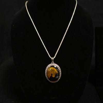 1296	STERLING SILVER NECKLACE W/STERLING PENDANT CONTAINING A COBACHON CUT AMBER W/INTRICATE REVERSE ENGRAVING OF A HORSE, CHAIN WEIGHS...