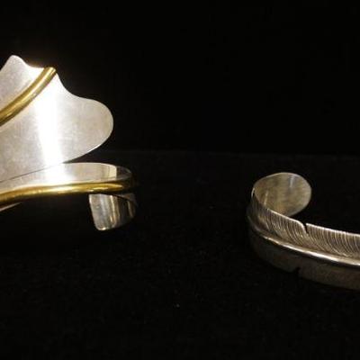 1245	2 STERLING SILVER CUFF BRACELETS, ONE IS MARKED MEXICO & ONE IS IN THE FORM OF A FEATHER, 1.399 OZT
