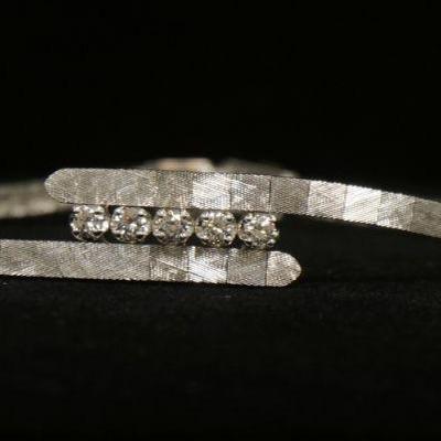 1199	14KT WHITE GOLD BYPASS STYLE BRACELET, 8.75 DWTS & CONTAINING APPROXIMATELY 0.35 CARATS OF DIAMONDS
