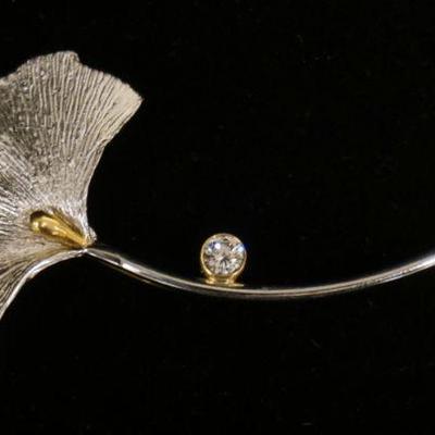 1192	PLATINUM & 18 KT YELLOW GOLD LEAF BROOCH, 8.80 DWTS & CONTAINING ONE DIAMOND APPROXIMATELY 0.24 CARATS, APPROXIMATELY 2 3/4 IN LONG
