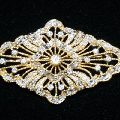 1166	14K YELLOW GOLD BROOCH PIN CONTAINING APP. 0.50 CARATS OF DIAMONDS. OVERALL WEIGHT 4.35 DWT
