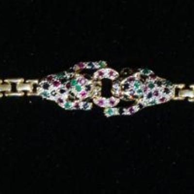 1240	14KT YELLOW GOLD JAGUAR BRACELET W/EMERALD, RUBY & SAPHIRE, ONE STONE MISSING, 6.2 DWT INCLUDING STONES, APPROXIMATELY 7 IN LONG
