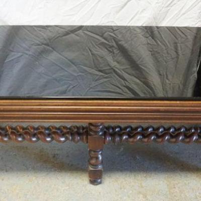 1292	BLACK GLASS INSET COFFEE TABLE IN WALNUT BARLY TWIST BASE, GLASS EDGE CHIPPED, APPROXIMATELY 19 IN X 42 IN X 17 IN H

