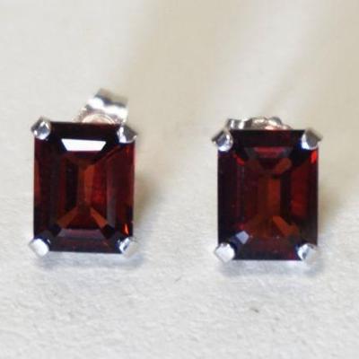 1143	PAIR OF 14K WHITE GOLD EARRINGS CONTAINING TWO EMERALD CUT RUBIES. 1.0 DWT INCLUDING STONES
