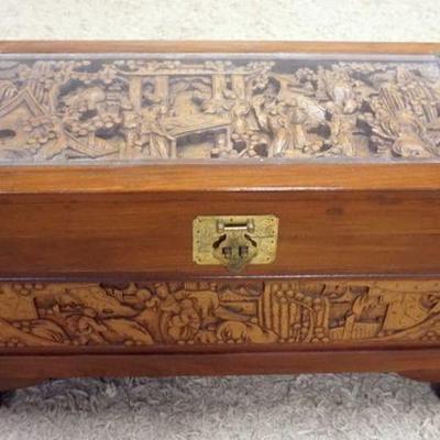 1165	HAND CARVED ASIAN CAMPHOR WOOD TRUNK WITH GLASS TOP AND BRASS CORNER MOUNTS, APPROXIMATELY 17 IN X 35 IN X 19 IN. HAVING CARVING ALL...