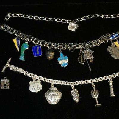1104	3 STERLING CHARM BRACELETS, MOST OF THE CHARMS ARE ALSO MARKED STERLING, 2.202 OZT OVERALL
