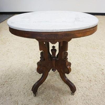 1054	VICTORIAN OVAL MARBLE TOP STAND, APPROXIMATELY 21 IN X 30 IN X 30 IN HIGH
