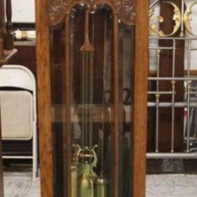 1021	CONTINENTAL OAK GRANDFATHERS CLOCK W/BEVELED GLASS IN CARVED DOOR, APPROXIMATELY 18 IN X 11 IN X 82 IN HIGH
