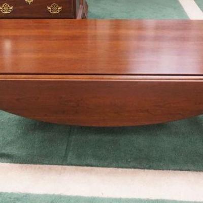 1030	STANLIS SOLID CHERRY QUEEN ANNE STYLE COFFEE TABLE W/DROP LEAVES, APPROXIMATELY 23 IN X 52 IN X 17 IN HIGH W/DROPS
