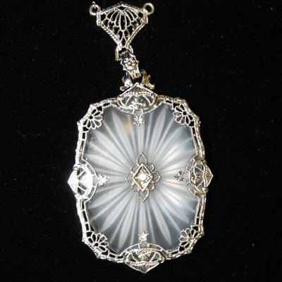 1144	10K WHITE GOLD PENDANT (UNMARKED BUT TESTS POSITIVE FOR 10K GOLD) APP. 2 IN L X 1 IN W
