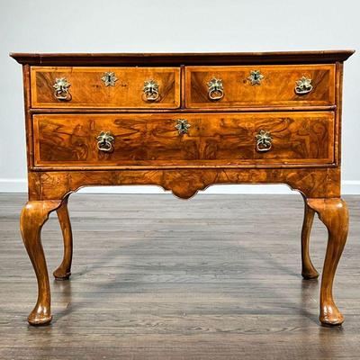 WALNUT VENEERED LOWBOY | Having two drawers over a full width drawer, sculpted apron, cabriole legs, with old 