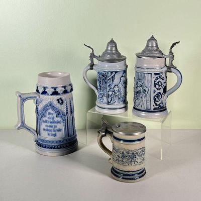 (4pc) METTLACH STEINS | Four blue and grey stoneware Mettlach steins from Germany, with pewter lids (one missing); depicting drinking...