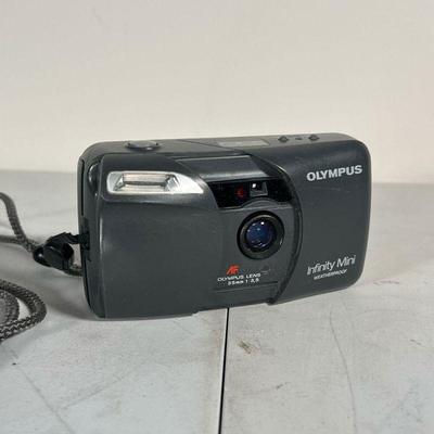 OLYMPUS INFINITY MINI | Olympus Infinity Mini Weatherproof 35mm point and shoot camera; film loaded in camera - l. 5 x w. 2 in.Â 