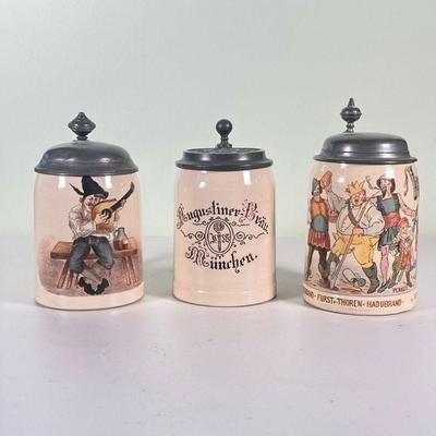 (3pc) 0.5L GERMAN STEINS | A set of three half liter German steins, each with lids and signed / marked on bottom (one marked Villeroy &...
