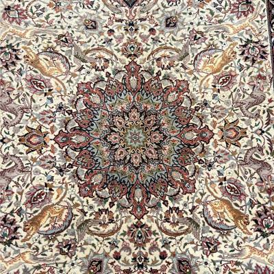SCULPTED ANIMAL KIRMAN CARPET | Having a central medallion on a cream field, surrounded by tigers and leopards, chasing antelope with...