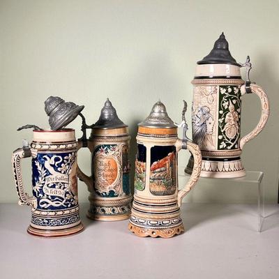 (4pc) METTLACH STEINS | Four Mettlach steins from Germany, finely sculpted and decorated, one with musical movement built into the bottom...