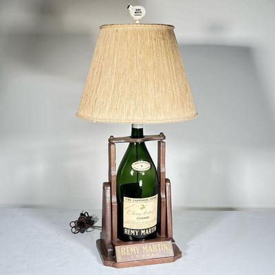 REMY MARTIN LAMP |
Large E. Remy Martin Cognac bottle converted into a table lamp with a wooden stand / base, with a Remy Martin finial -...