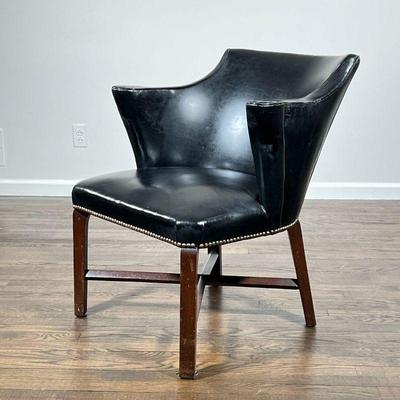 ANTIQUE LIBRARY ARMCHAIR | Black vinyl upholstery with scroll arms and brass tacks, on a wood frame base, no apparent maker's mark - l....