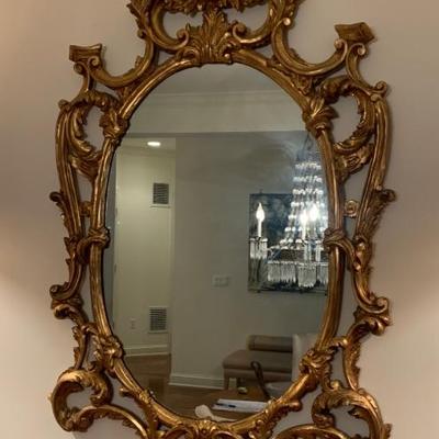 Carved oval gilded mirror