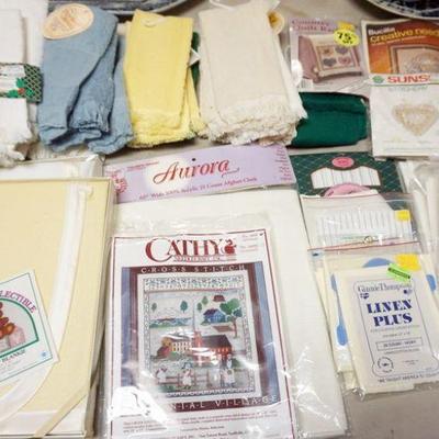 1309	LARGE LOT OF INCLUDING CROSS STITCH KITS, CROSS STITCH AID CLOTH OF DIFFERENT WEAVES AND SIZES, AID QUILTS, TABLE CLOTH, HAND TOWLS...