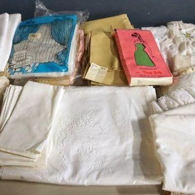 1308	LARGE LINEN LOT INCLUDING TABLE CLOTHS, NAPKINS, CURTINS, DOILIES AND MORE
