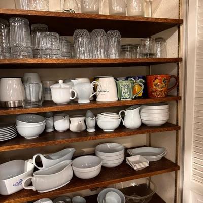 Full Kitchen of plates, cups, pots, pans, utensils, small kitchen applianes, decor, and more