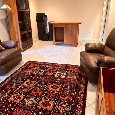 Tribal Area Rug, Large Faux Leather Recliner Chairs, Wood Bar, Vintage Glass Front Cabinet, Land Furniture Chest, and Audio Speaker...