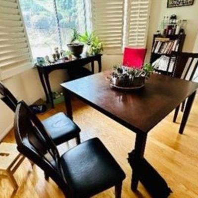6 seat dark wood table.  Chairs included, has red seat covers if choose to go.