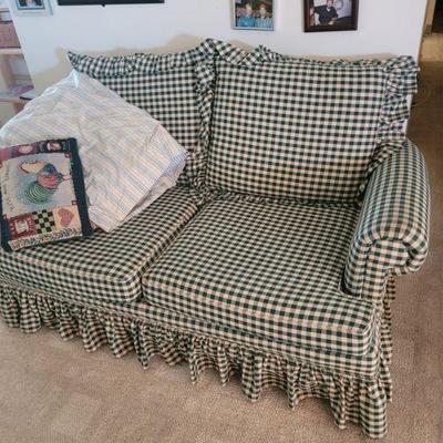 Fabric covered love seat with a checkerboard pattern