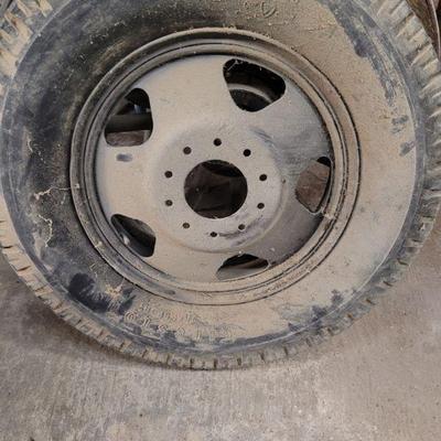 Old truck wheel with an inflated Firestone tire