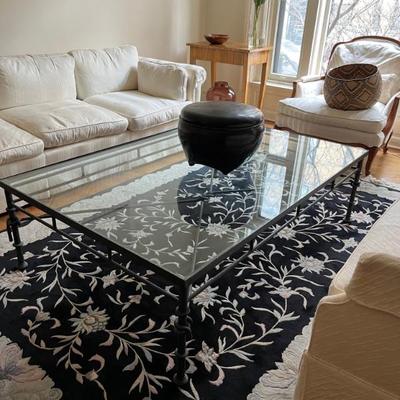 glass topped coffee table on modern black metal base, 18