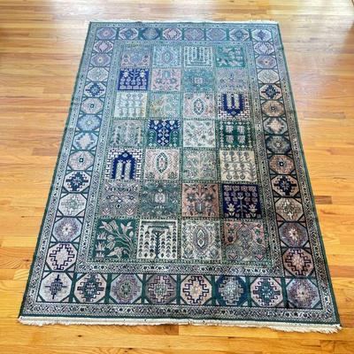 GEOMETRIC FLORAL RUG | Green rug with fringe, having a geometric outer border surrounding a field of square floral patterns - approx. l....