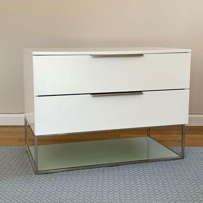 SMALL WHITE CREDENZA | Modern style side table of small size, having two drawers with chrome hardware and a lower shelf with glass floor...