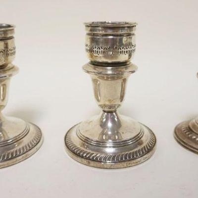 1076	STERLING WEIGHTED CANDLESTICKS LOT OF 3, TALLEST APPROXIMATELY 5 IN
