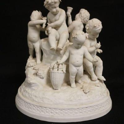 1033	BISQUE FIGURE OF CHERUBS EATING GRAPES & DRINKING WINE, APPROXIMATELY 10 1/4 IN HIGH
