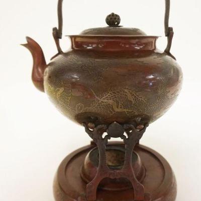 1031	ANTIQUE ASIAN COPPER & BRASS TEAPOT ON STAND W/ETCHED DRAGONS, TEAPOT W/HANDLE APPROXIMATELY 7 IN HIGH

